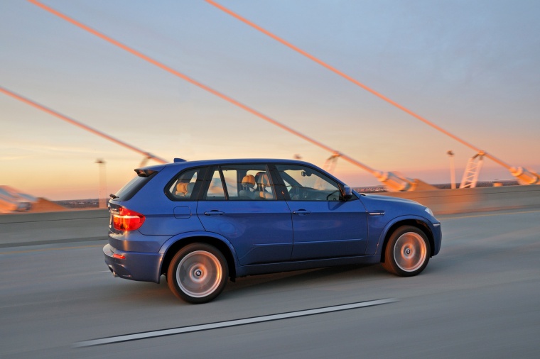 Driving 2013 BMW X5 M in Monte Carlo Blue Metallic from a right side view